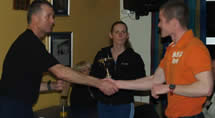 Hywel Davies. Winner of this years Indoor Ironman held at Brooklands LA Fitness being handed his trophy by organiser Stuart Leng.